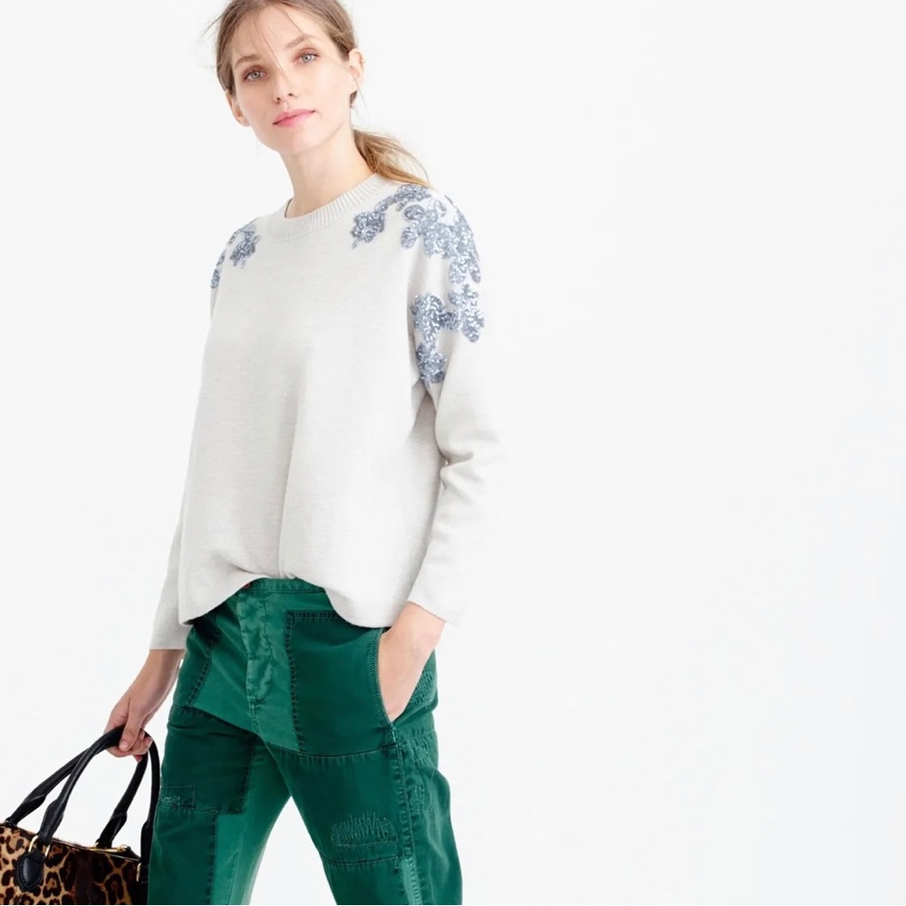 Easy merino sweater with a sequin floral motif across the shoulders.